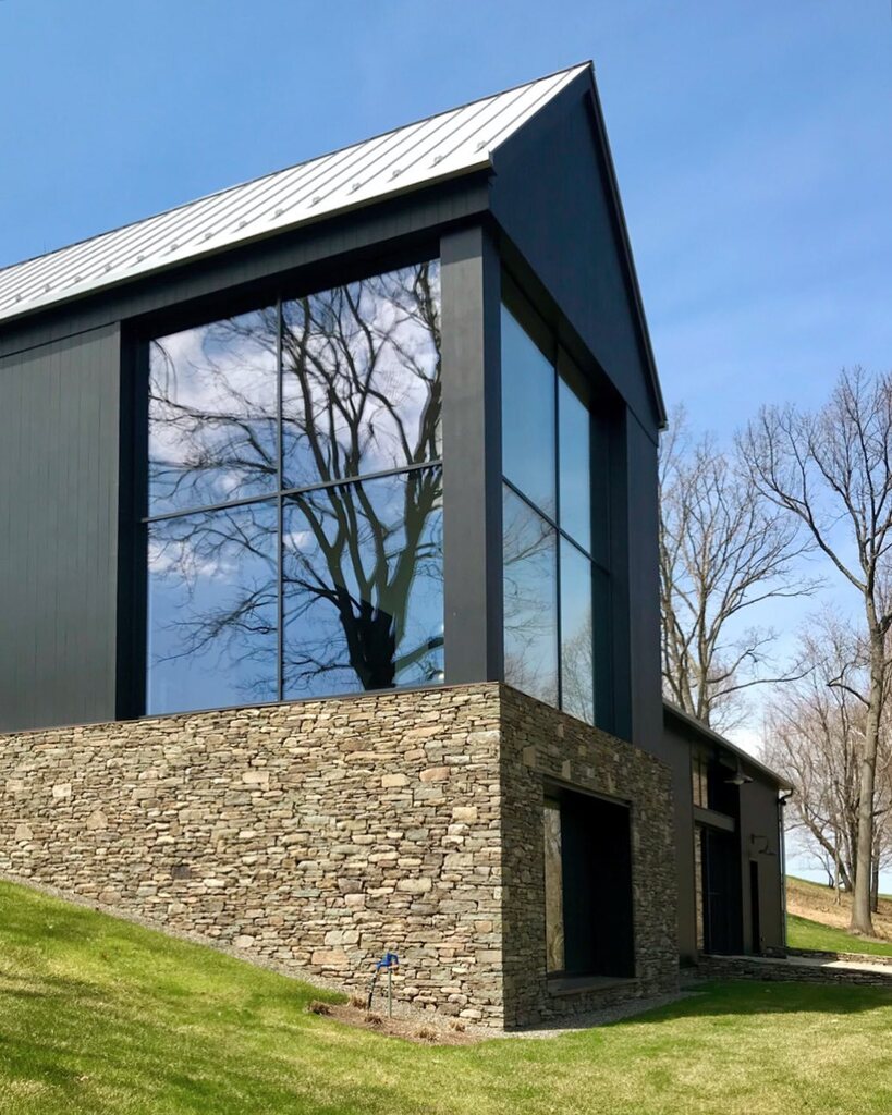 Mowery_Marsh's tweet photo. Wondering what’s on the other side of that charming black house and bridge? 🤔
Here you go! Nestled into the hillside, the large scale of this fieldhouse is minimized at the approach and then opens up into views of the surrounding woodlands. 🍁
Who says #PassiveHouse can’t hav… https://t.co/h5Dv4jwAuh