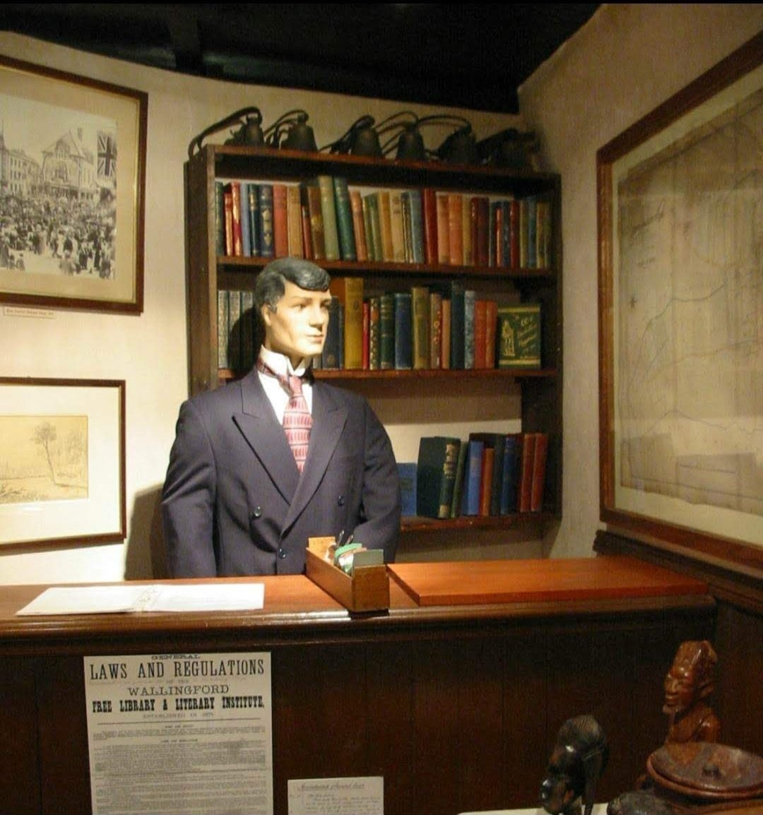 Our model was originally from local business Pettits (Est March 1856 by Mr W Pettit) &amp; was donated to us after being The witch of Ilges Lane in 1986 exhibition for #Cholsey millennium. Here he's Librarian of #Wallingford Free Library with #Bookshelves. #Museum30 <a href="/WeirdMannequins/">Weird Mannequins</a>