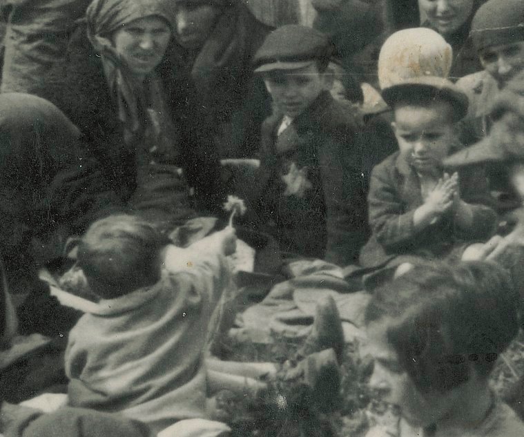 AuschwitzMuseum's tweet image. #WorldChildrensDay | A heart-breaking moment captured in an SS made picture of Hungarian Jews at #Auschwitz II-Birkenau in 1944. A child found a dandelion in the grass and is giving or showing it to an older boy. All the people in the picture were gassed soon afterwards.