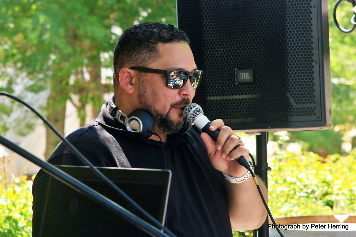 PeterHerring's tweet image. The inimitable Mr @DenverA doing what what he does best. Behind the desk rocking the house at DNA Cafe's #FTLOI fund raiser at Morgenhof Wine estate. So good seeing you again.