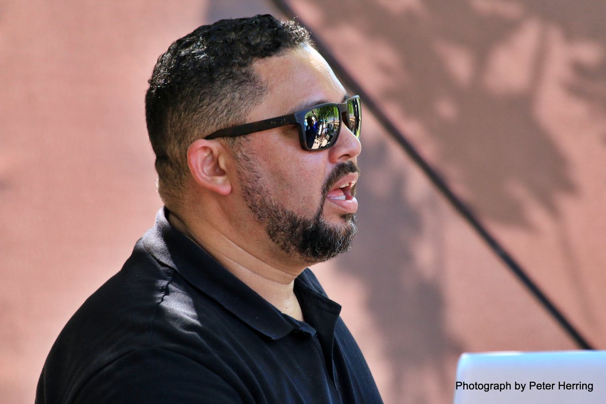 PeterHerring's tweet image. The inimitable Mr @DenverA doing what what he does best. Behind the desk rocking the house at DNA Cafe's #FTLOI fund raiser at Morgenhof Wine estate. So good seeing you again.