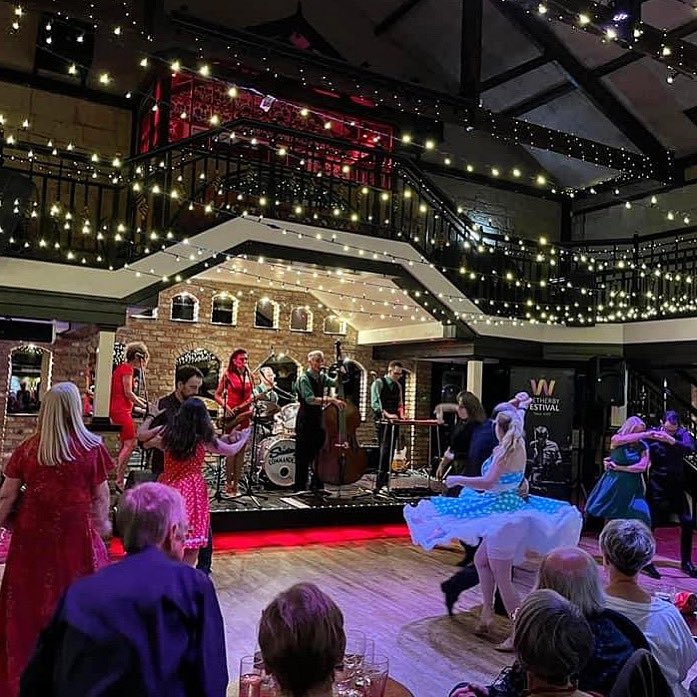 swingcommanders's tweet photo. Playing at @engineshedwetherby a few weeks back as part of Wetherby festival! 
#fairylights #musicvenue #wetherby #ladiesinred #swingband #westernswingband https://t.co/Q1Sij1Jf14