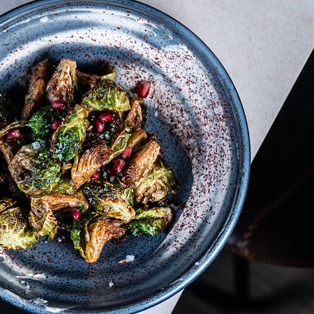 A Fall Favorite! Brussels are back on the menu ~ and these are crispy and tossed with tahini, lemon, and pomegranate seeds.