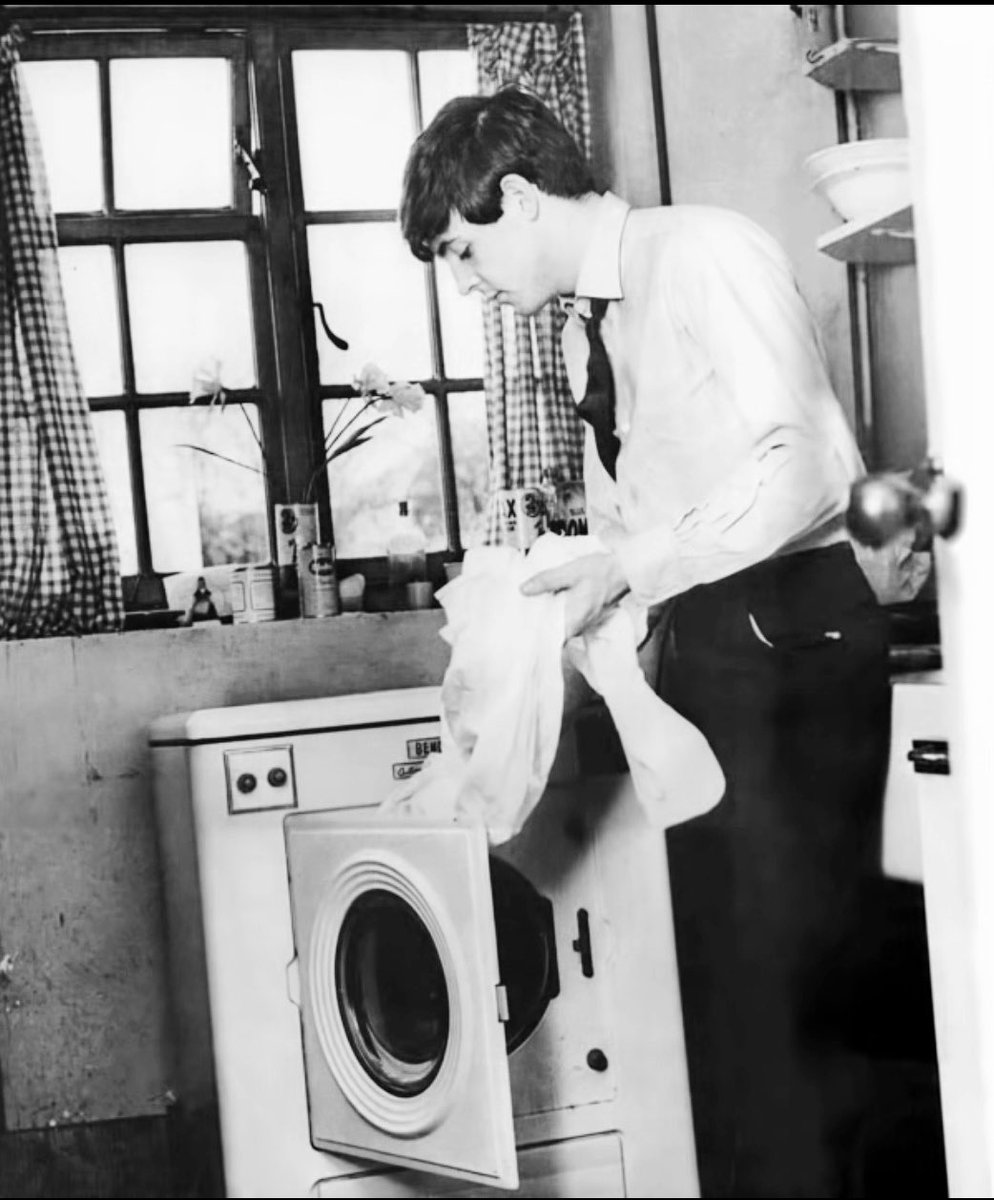 At 20 Forthlin Road Liverpool, Paul McCartney does washing.