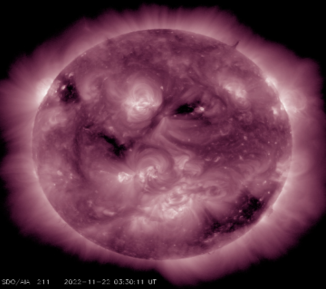 Image of the Sun in purple color scheme with dark splotches arranged to mimic a face.