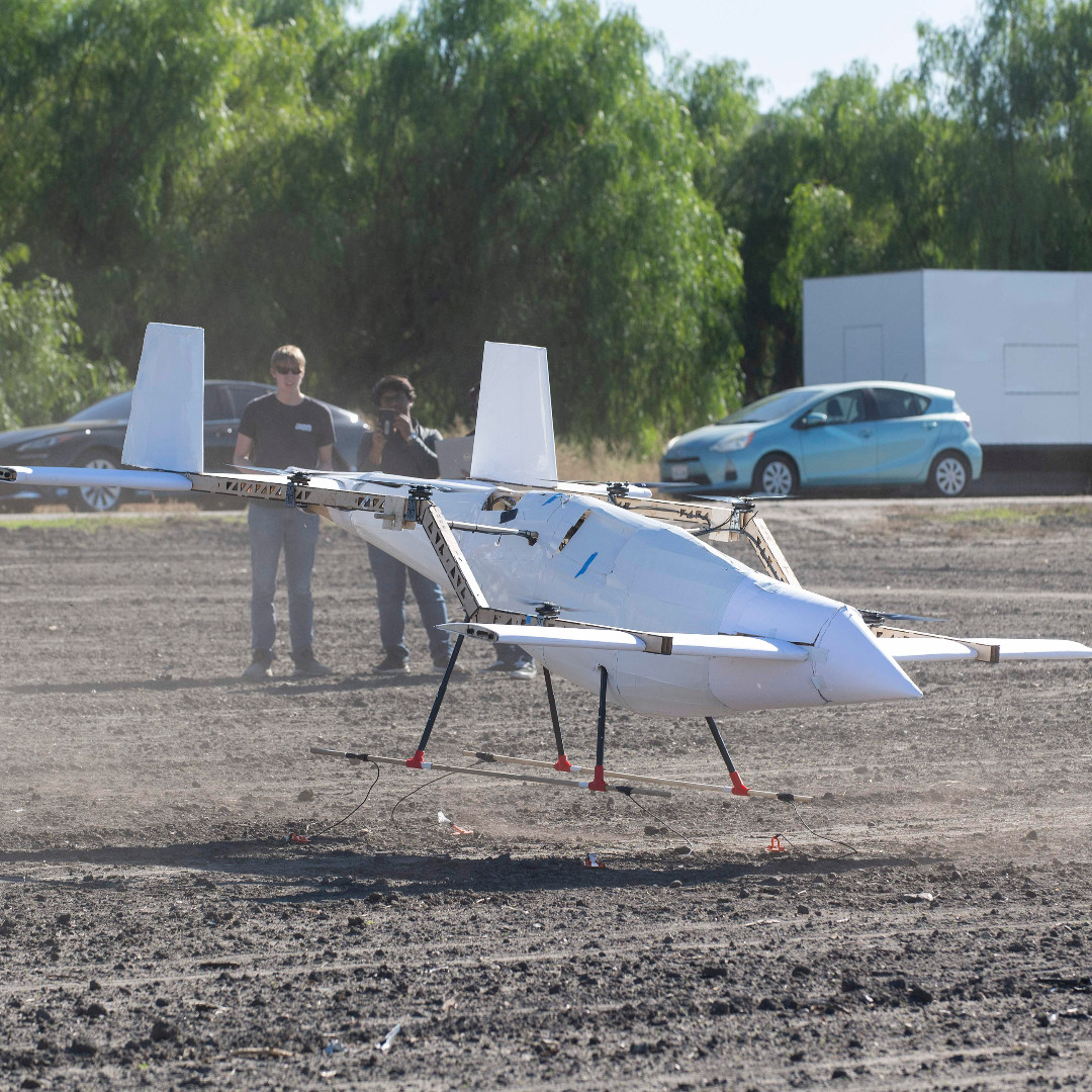 Students set up an eVERT aircraft as it takes flight for a hover test at Spadra Farm.