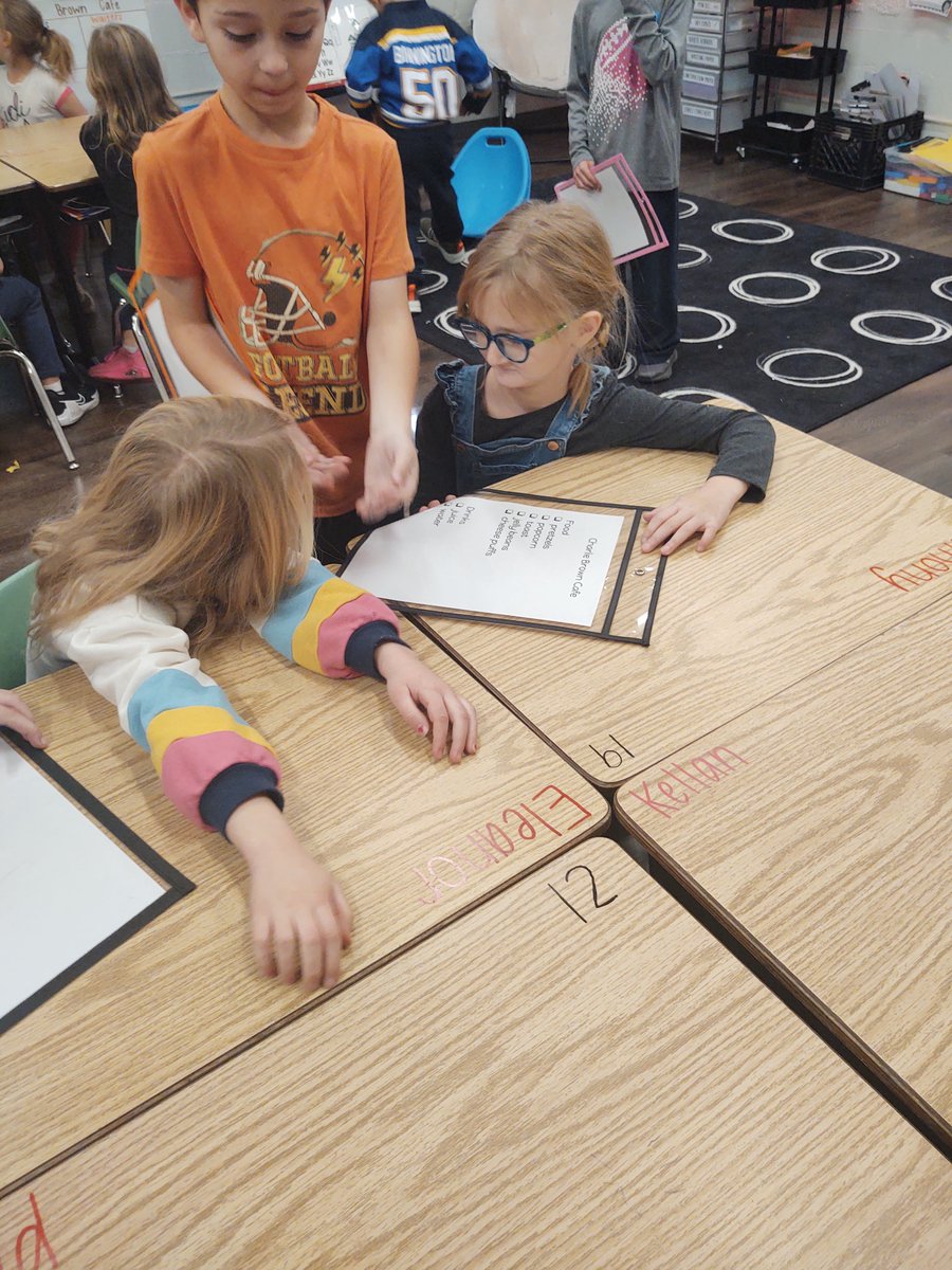 Our sweet 1st graders practicing to be restaurant staff for tomorrow's feast. So excited!