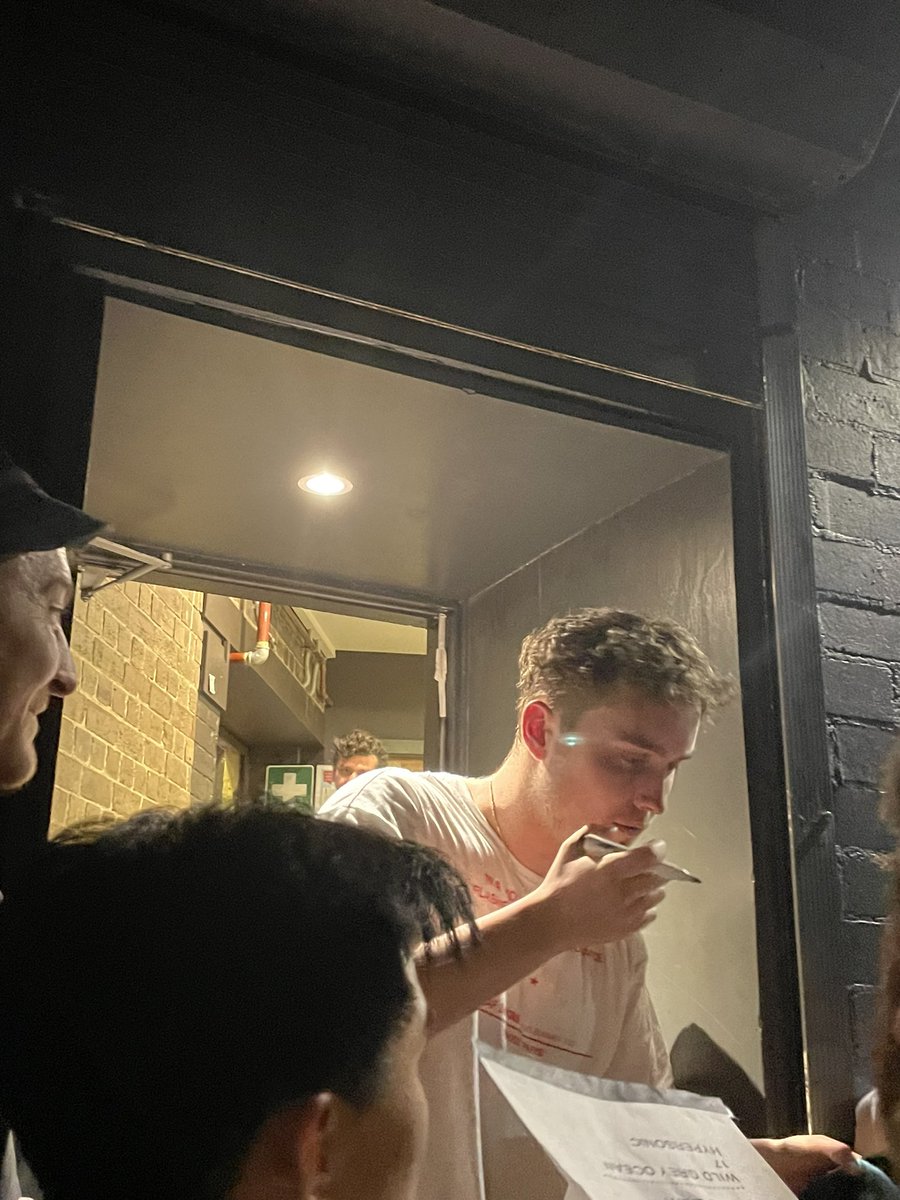 mismatchedmich's tweet photo. sam fender casually opening the door with a glass of red wine and proceeding to chat shit literally telling everyone his old address unprovoked no filter at all just vibes https://t.co/khtAWIfcFt