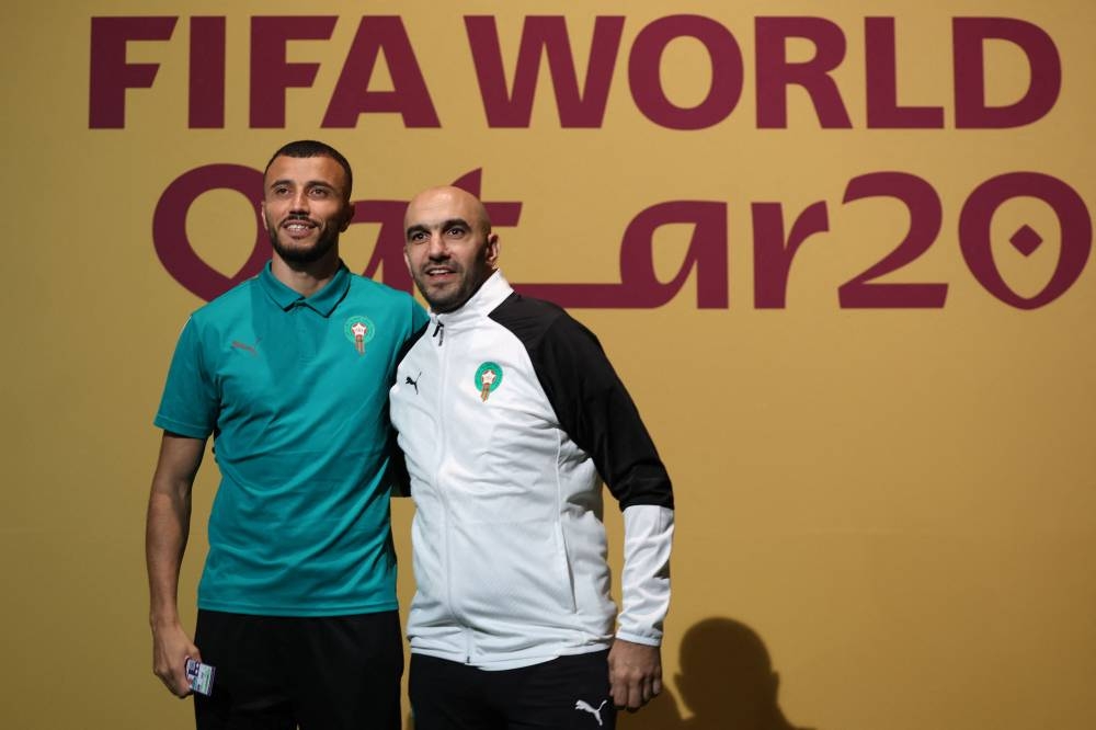 Morocco's coach Walid Regragui and defender Romain Ghanem Saiss arrive for a press conference at the Qatar National Convention Centre (QNCC) in Doha, on 22 November 2022, on the eve of their Qatar 2022 World Cup football match between Morocco and Croatia.

📸 Fadel Senna / AFP