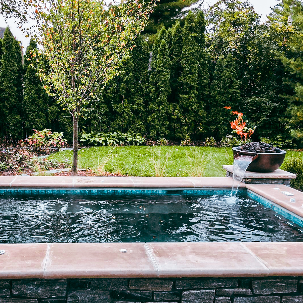 Elevate your pool to a work of art with a custom water feature.