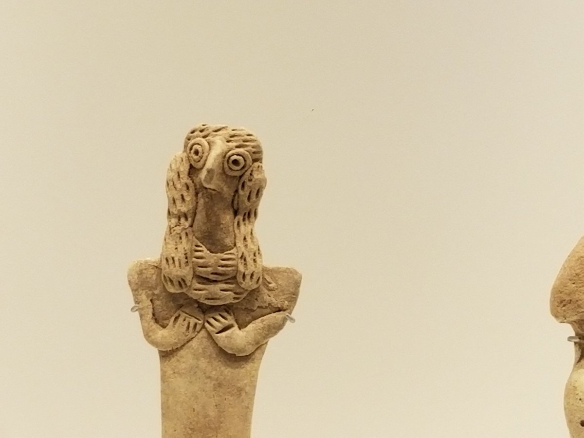 3000 year old figure with buggy eyes and an almost bird-like face.