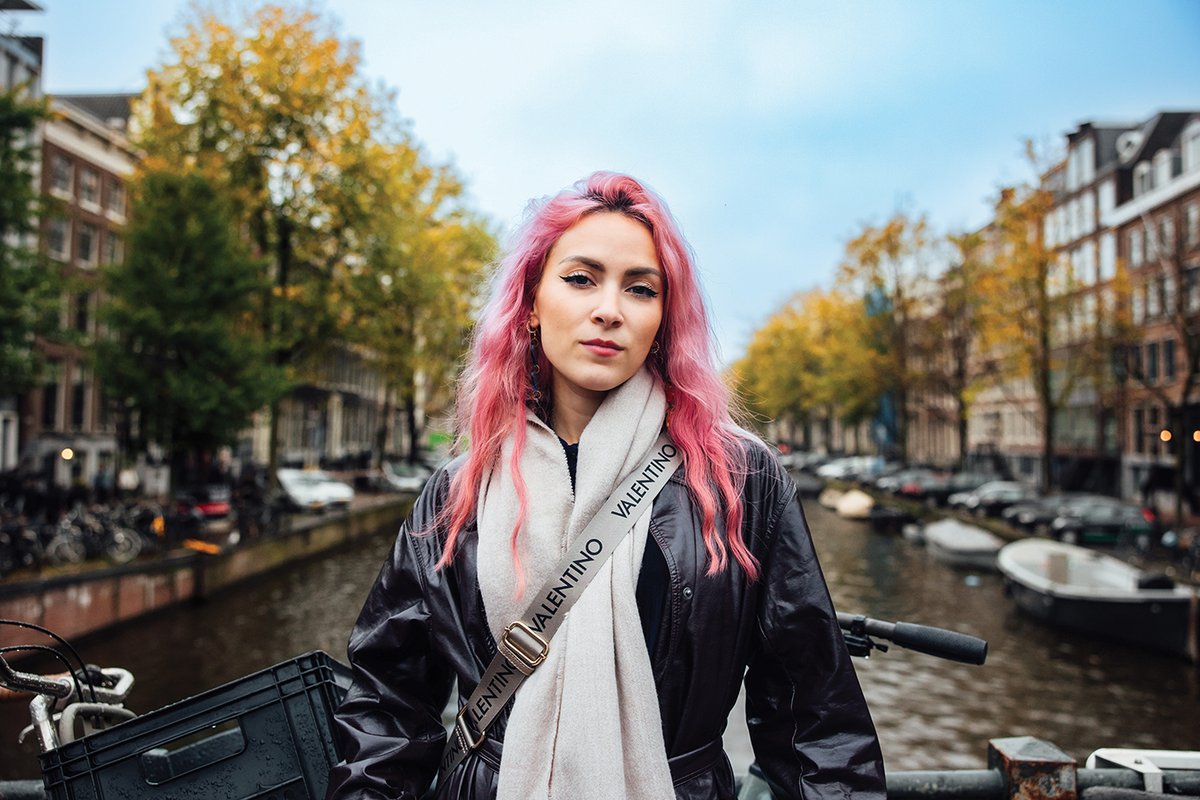 Camden Cox standing on a bridge over a canal in Amsterdam