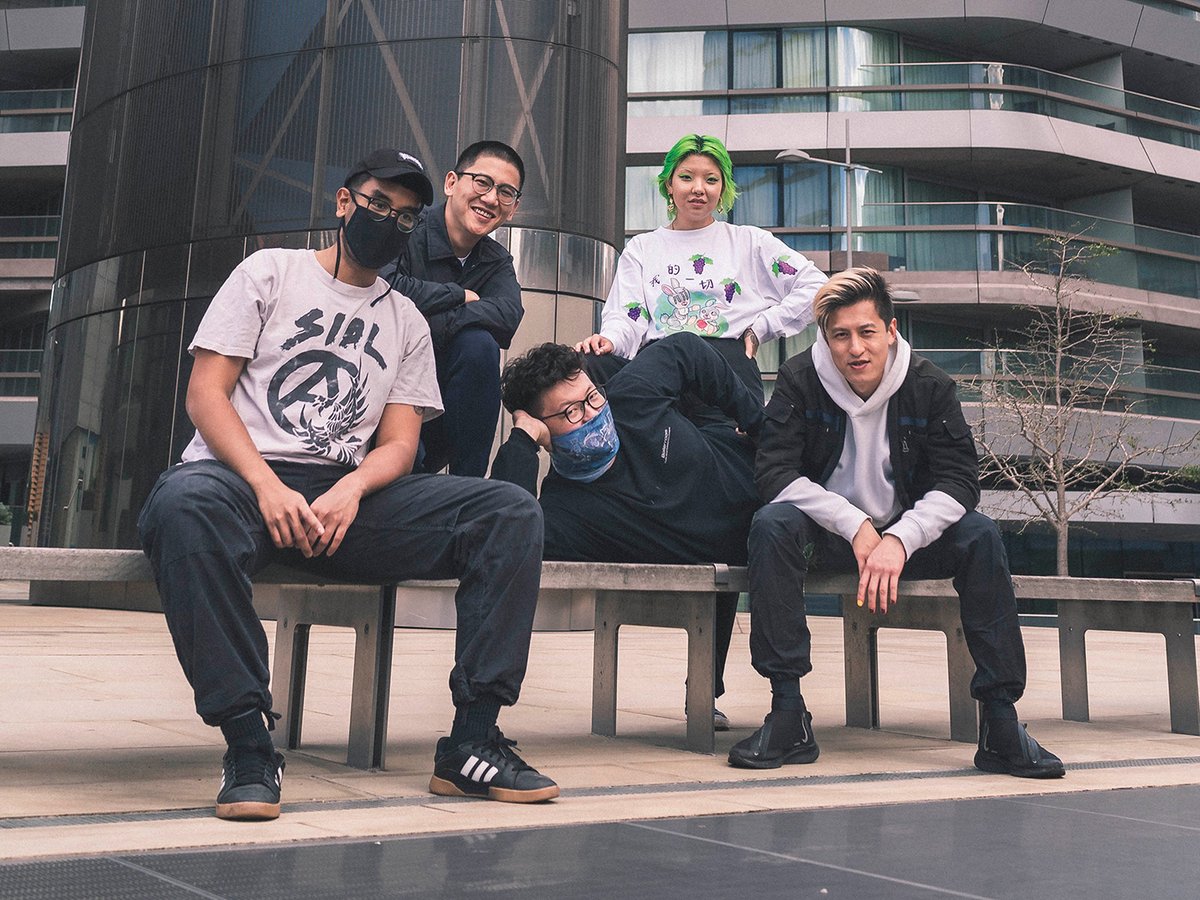 Members of the Eastern Margins collective sat on a bench