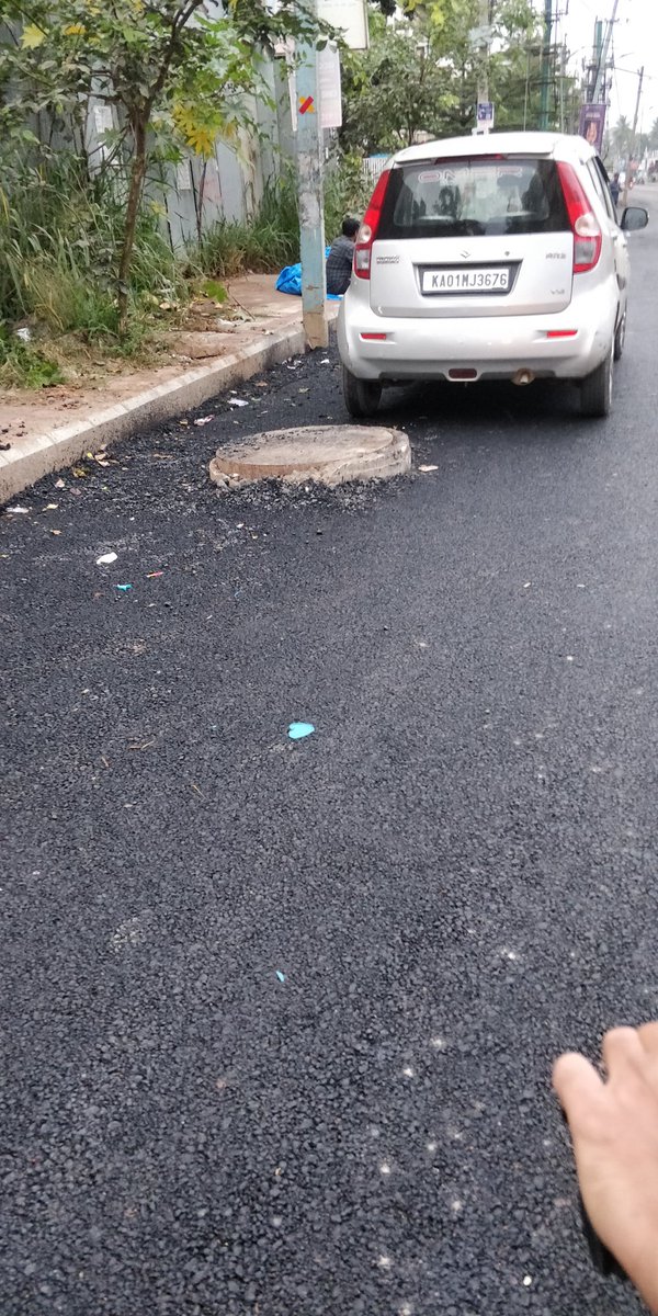 hkallae's tweet photo. @MTF_Mobility there are these man holes left above the road level, which can cause accidents. Can you get this fixed? also can the transformer be moved and the road can be extended? This is near SSVR Tridax apartment balagere road. https://t.co/5Ki2Ob6Xmf