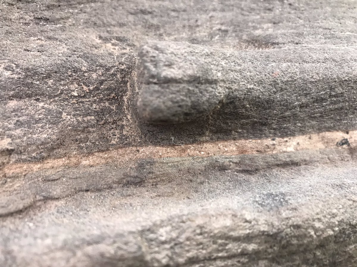 Close up of pieces of stone. A fine layer of pink mortar.