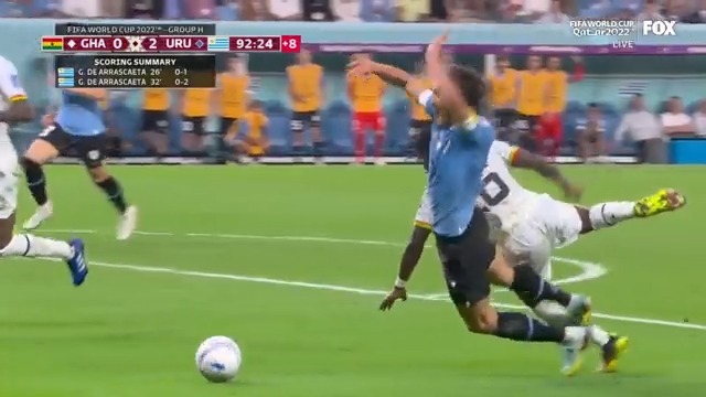 Uruguay calls for a penalty on this challenge in a box, but none is given by the referee”