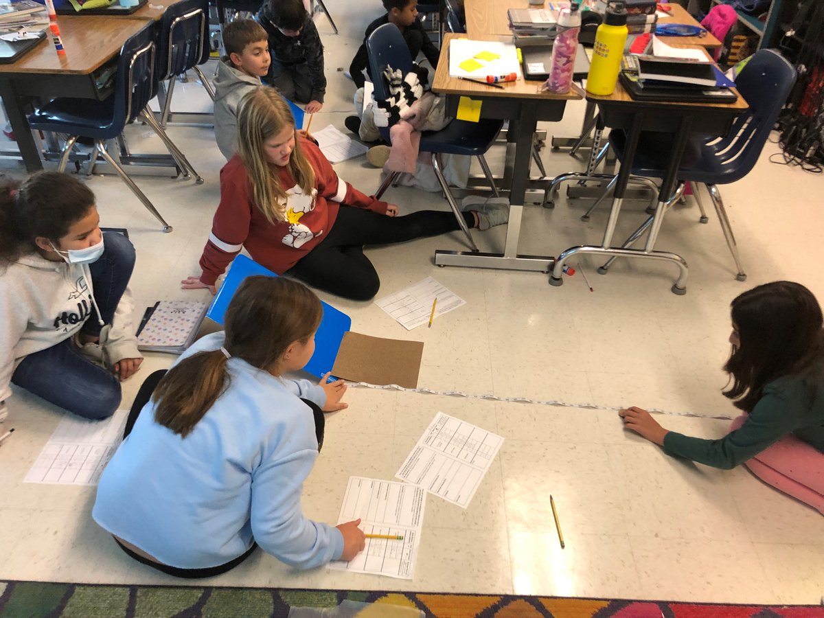 5th graders are experimenting to see which surface material creates more or less friction.