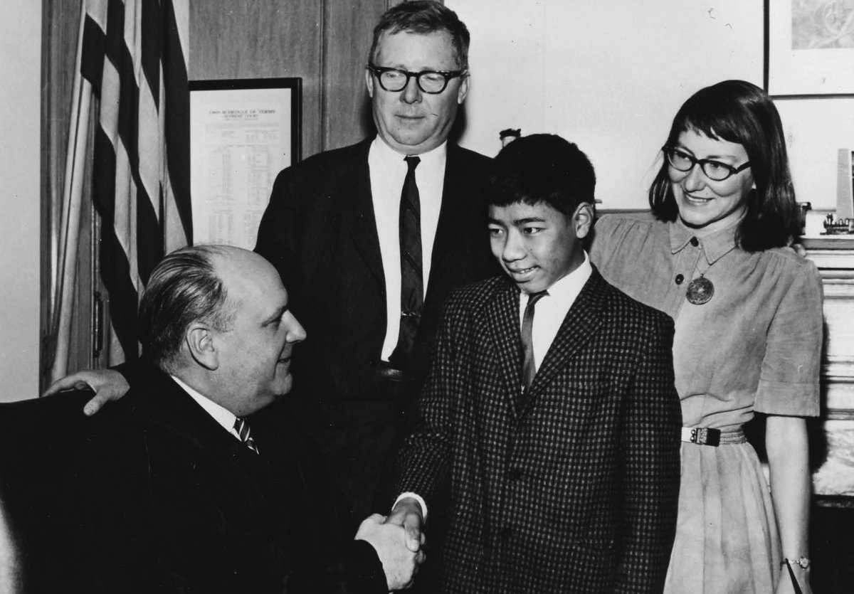12-year-old Tempa Westbrook's adoption story was a journey of several thousand miles from his birthplace in Tibet. In this 1965 photo, he smiled with his parents as he was congratulated on his citizenship by NY Supreme Court Justice John H. Pennock. #NationalAdoptionMonth