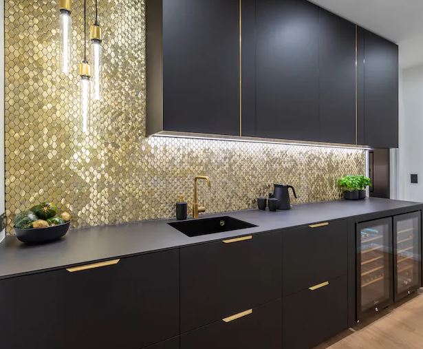 This minimalist black and gold kitchen is breathtaking! The bespoke island features Dekton Sirius, a rich matte black worktop that seamlessly compliments the cabinets. Dekton's heat and scratch proof properties make it a great practical choice for any kitchen. #Horsham #Dekton