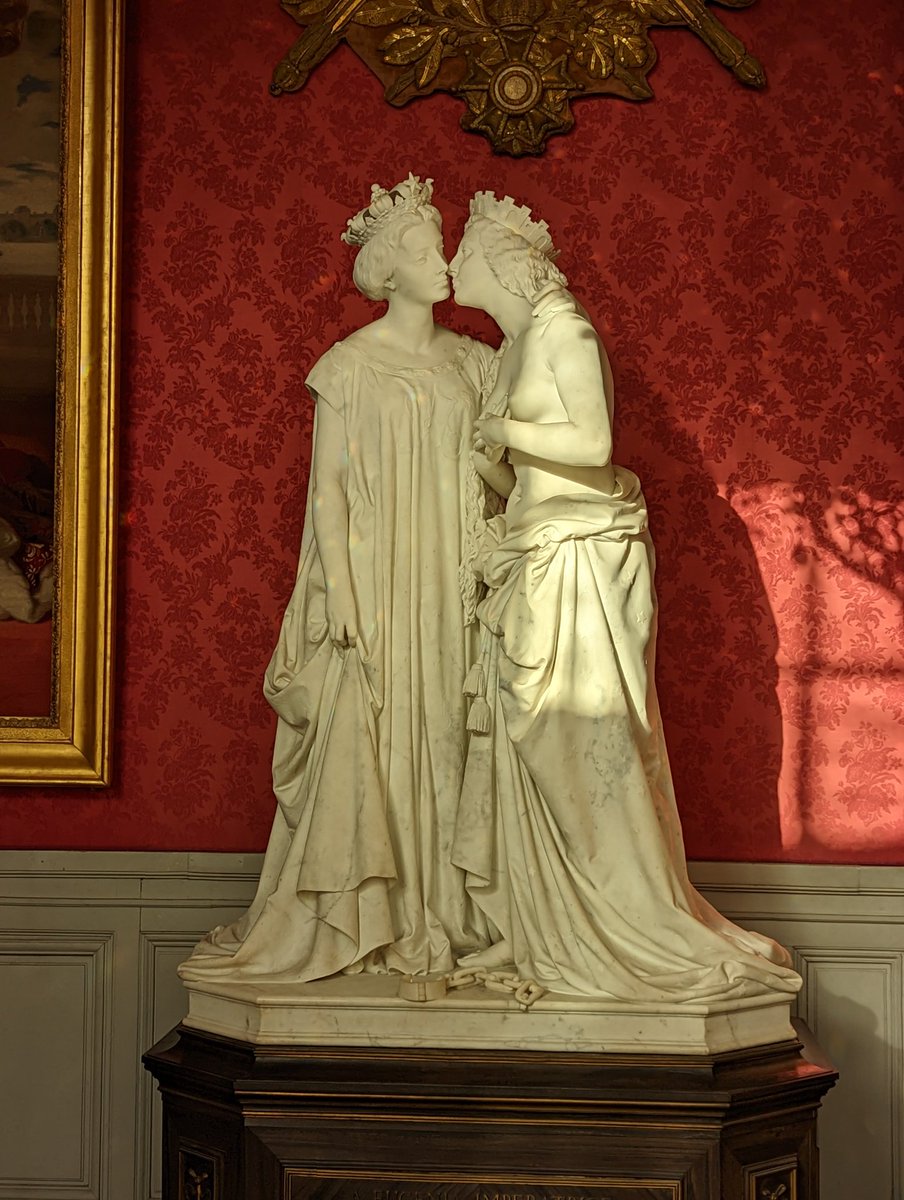 Italy, on the right wearing the mural crown, kissing France