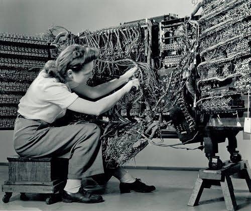 A photo by Berenice Abbot of a woman wiring an IBM computer, 1948.