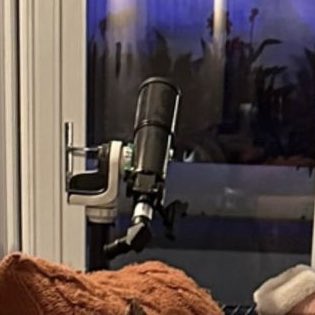 THE TELESCOPE. SHE LOOKS AT THE STARS.