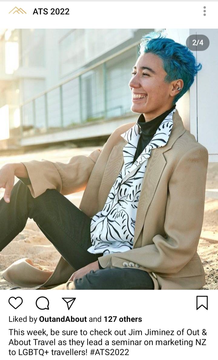 ATS IG account: image of Jim in a suit on the beach. Caption reads "This week, be sure to check out Jim Jiminez of Out & About Travek as they lead a seminar on marketing NZ to LGBTQ+ travellers! #ATS2022 