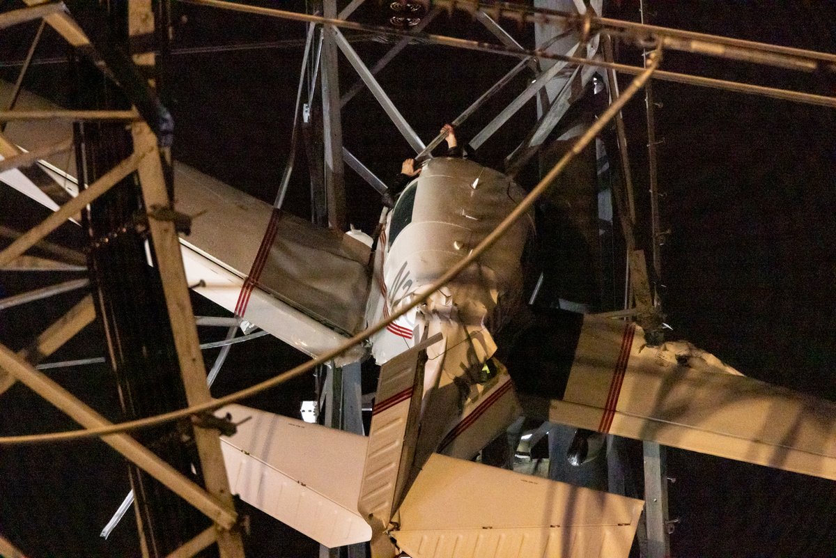 markman100's tweet photo. Sunday night plane crashed into power tower near my house in Gaithersburg, MD. The pilot can be seen holding on to the tower strut through the broken windshield. Power was shut off to 100K customers at one point. #BREAKING #Maryland #planecrash #Marylandplanecrash https://t.co/86djO2c9Bk