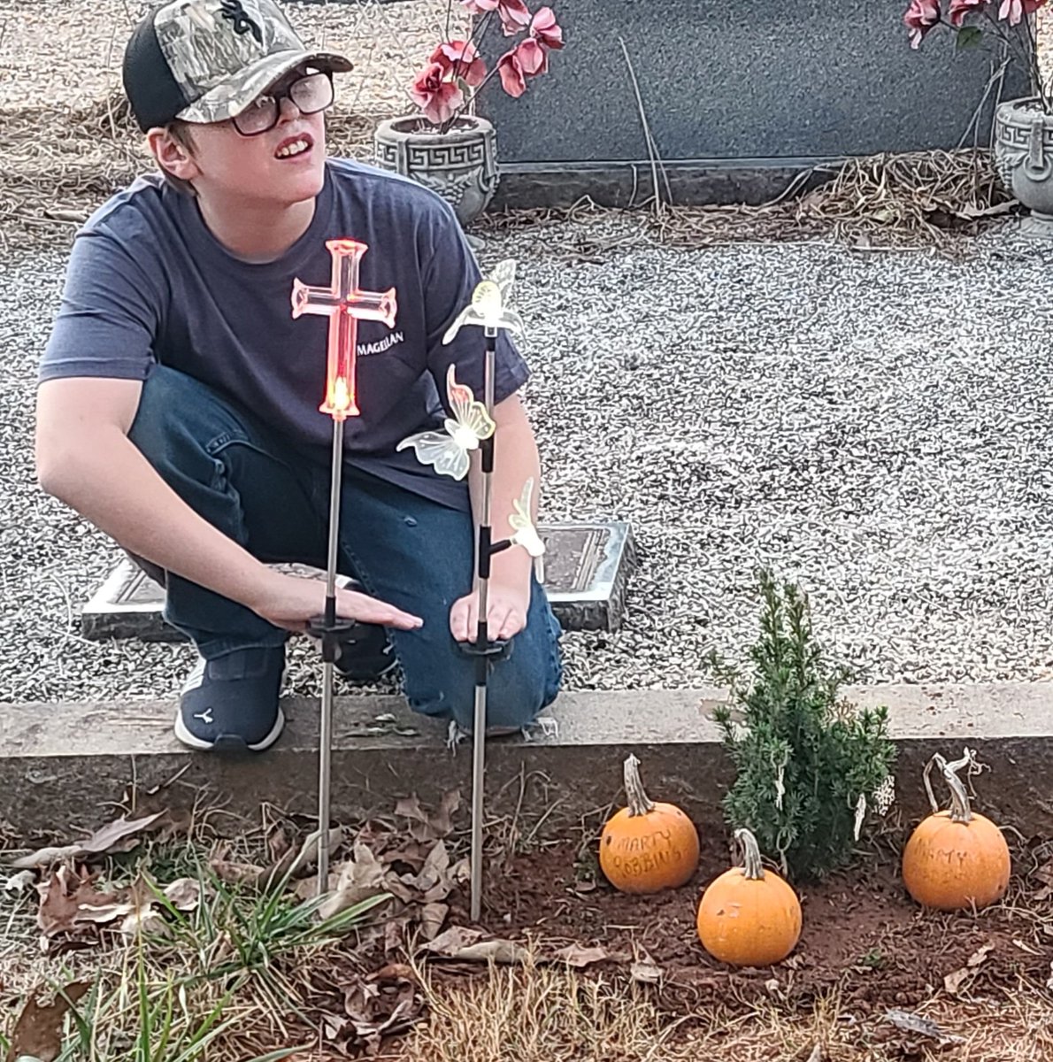 We went to visit Daddy Sunday, and my Mama planted a Christmas tree for him. I love it. We can decorate it every year, and add more as it gets bigger and bigger...