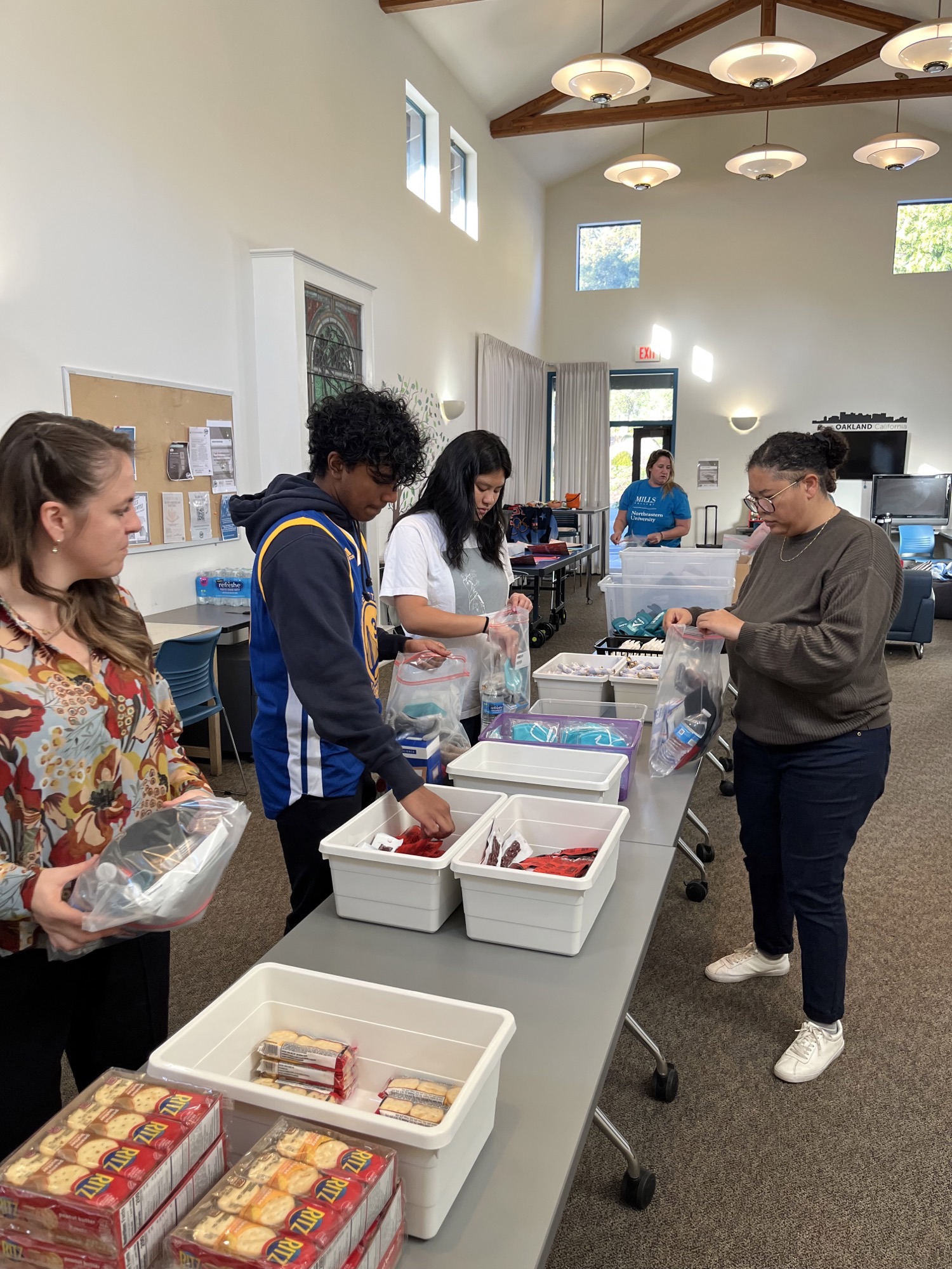 Mills at Northeastern students and staff put together care packages as part of East Oakland Collective’s Feed the Hood program.