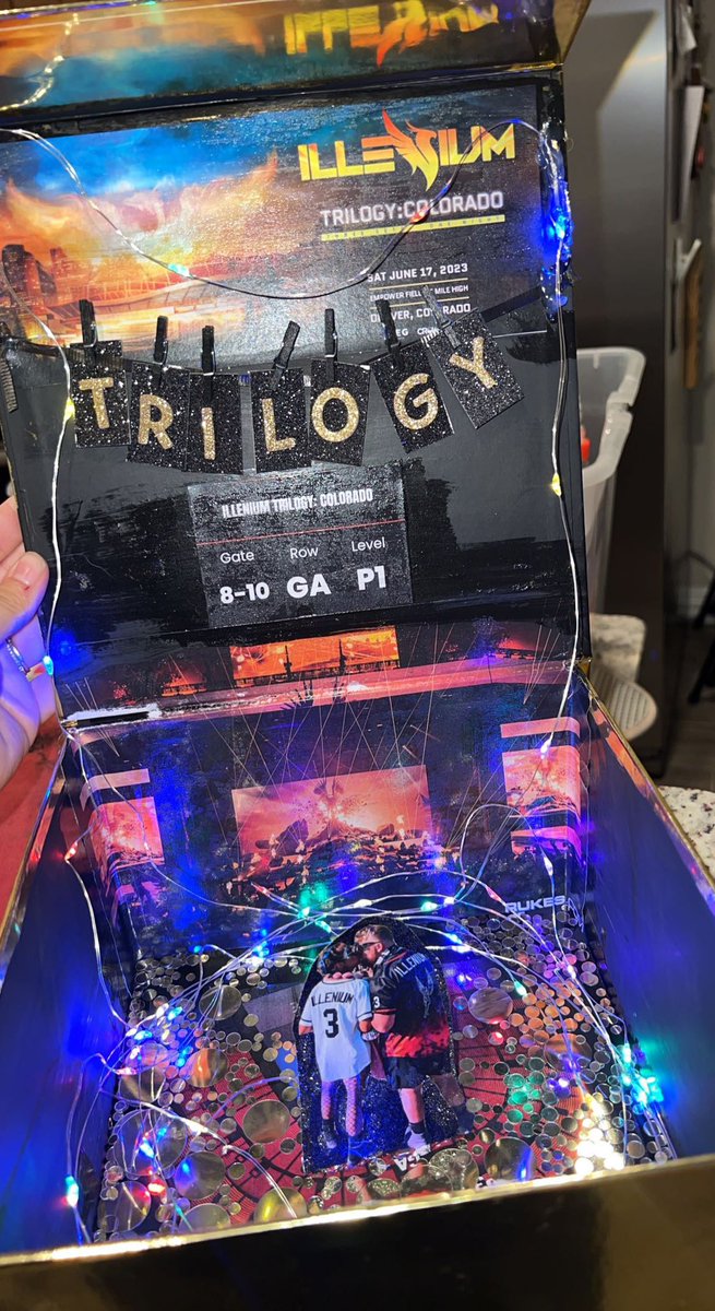 chels_g9's tweet photo. finally gave my husband his bday present by giving him clues to solve throughout the day &amp; the box at dinner tonight. been keeping this a secret since july🥲✨🫶🏼 we can’t wait @ILLENIUM 🧡💛❤️ https://t.co/CoHGvre0ja
