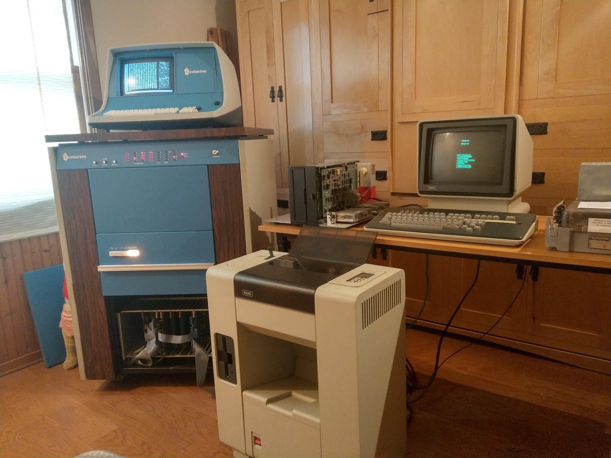 Two very different machines up and running next to each other!
The Centurion is booted into TOS6, the expanded memory monitor, off the 8-inch floppy drive, and the Wangwriter is booted into Wang's Word Processing software off it's internal 5-1/4" floppy drive.