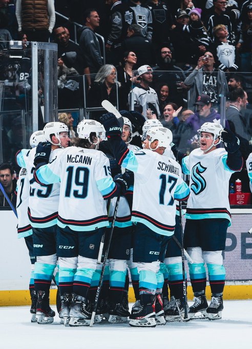 The team celebrates on the ice after the overtime winning goal