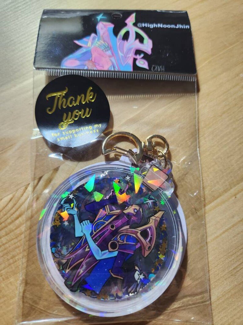 HighNoonJhin's tweet photo. I got new Dark Cosmic Jhin shaker keychains in my shop! 
https://t.co/a5LeHdmtlf

(free sticker with every one!) 

a new batch of bodypillows (dcj and classic) coming soon
#leagueoflegends #jhin #leagueoflegendsjhin https://t.co/FyoMDTiGXT