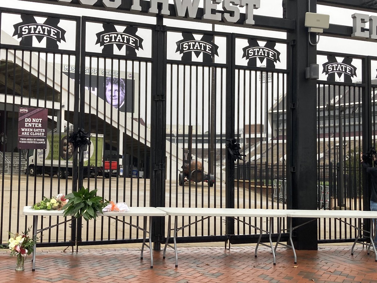 They’ve affixed black ribbons to the Southwest Entry Gate here and have put up a table with flowers in Mike Leach’s memory.