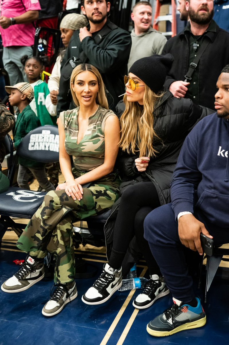 Kim and Khloé at a basketball game yesterday.