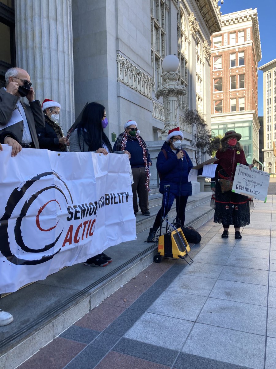 sdaction1's tweet photo. Bring back masks in public buildings! #Masks4Equity picture of a group of people on steps of Oakland city hall, holding an SDA banner and signs. https://t.co/mTW0l97iXk