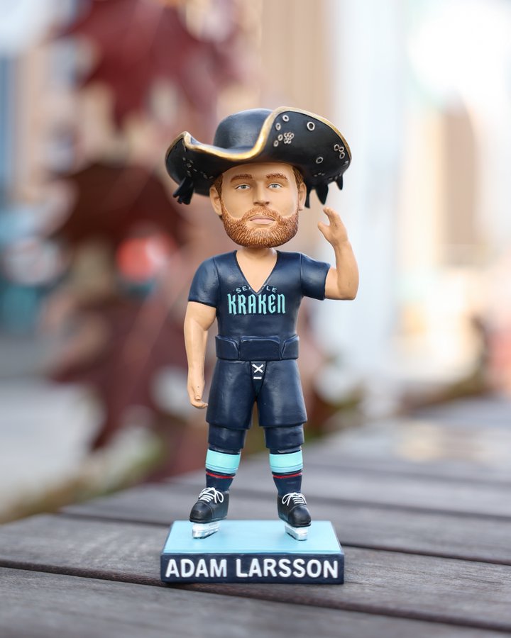 Adam Larsson bobblehead. bobblehead is waving, wearing the davy jones hat and wearing a t-shirt cut to have a deep v neck