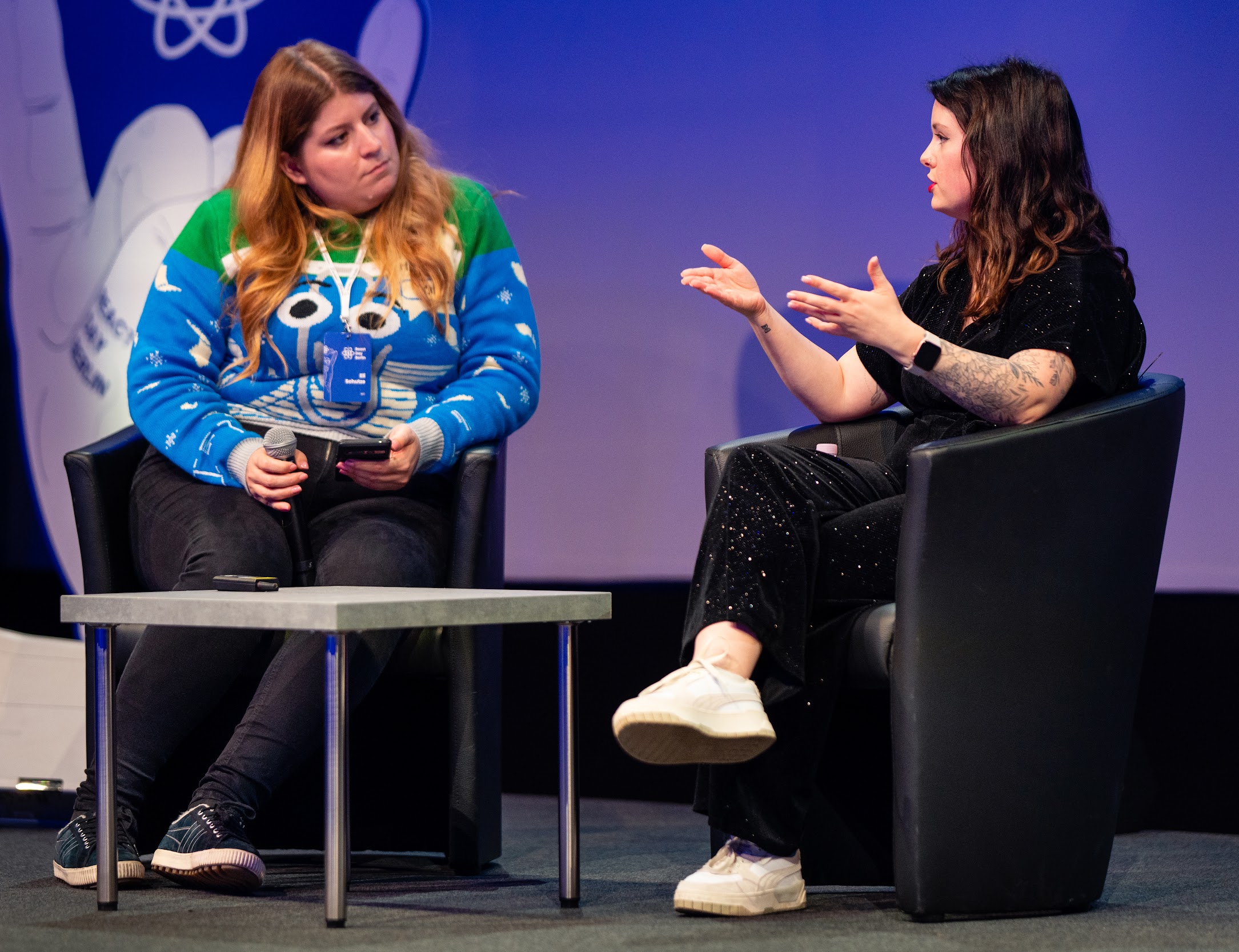 Emma speaking with Eli on stage