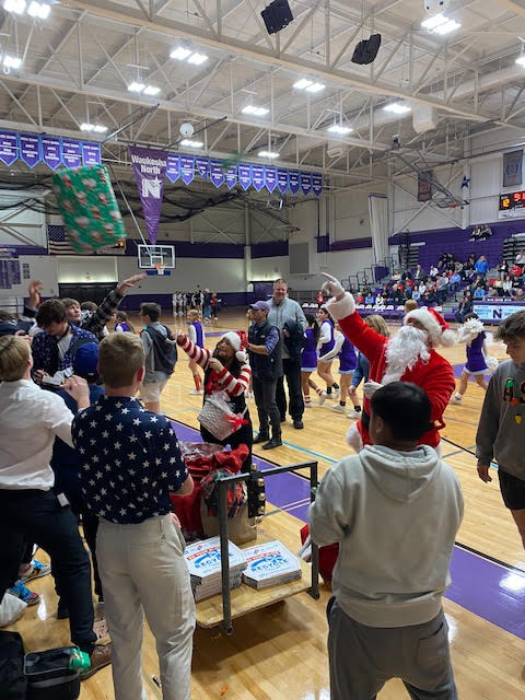 WaukeshaNorth1's tweet photo. Santa Claus paid a visit to North for our basketball game last night! He and Mrs. Claus passed our presents and pizza to our fans! (Thanks to the McCains for "arranging" Santa's visit!) https://t.co/yGpHQz46G4