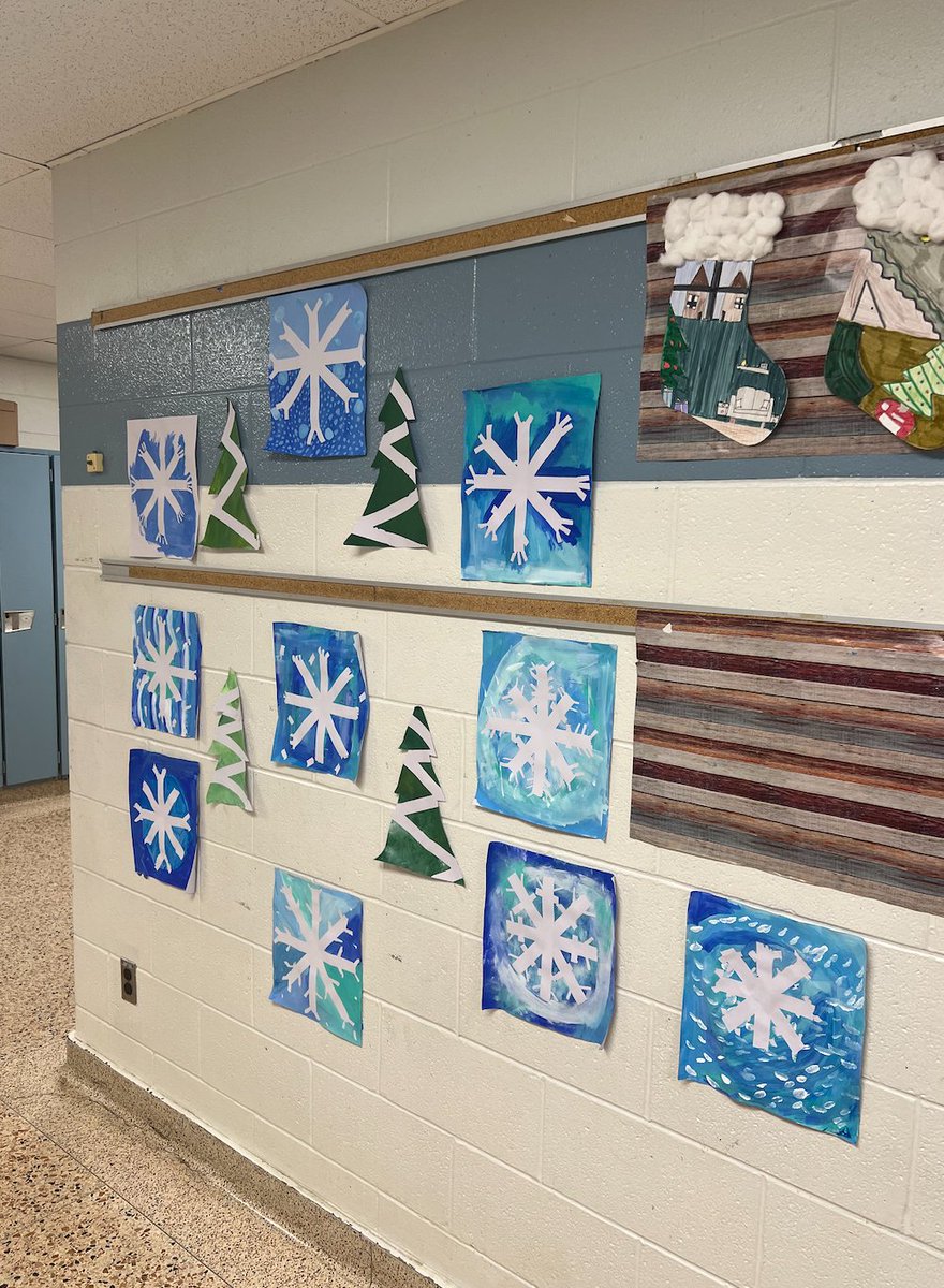 MissEmmaB_'s tweet photo. Our Christmas wall! A combination of two different art lessons. We drew our favourite Christmas memories on stockings for our first lesson. Our second lesson was tape resist art Christmas trees and snowflakes!🎄❄️ @PJLanguageArts https://t.co/bcGnp2OKzO