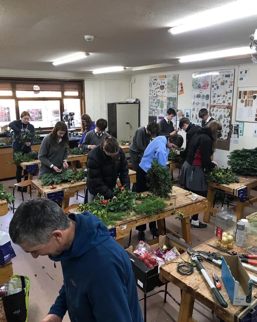 Students and staff making wreaths to be sold tomorrow