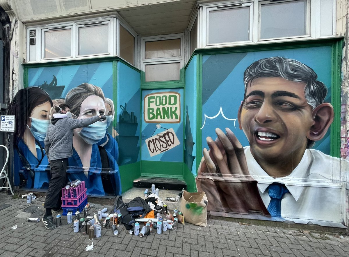 beardedjourno's tweet image. SledOne is putting the finishing touches to a new mural on North Street ahead of tomorrow’s nurses strikes. NHS nurses are queuing in front of a food bank while Rishi Sunak claps. A message to finish the piece will read: “Don’t just clap, give nurses fair pay.”