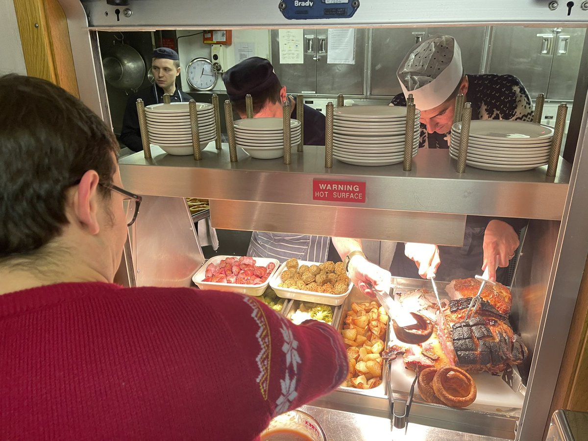 The Commanding Officer and Executive Officer putting a shift in the #galley serving the Ship’s Christmas lunch. Always under the watchful eye of the Leading Chef! 👨‍🍳 We would like to wish everyone a Merry Christmas and a Happy New Year. 🎄