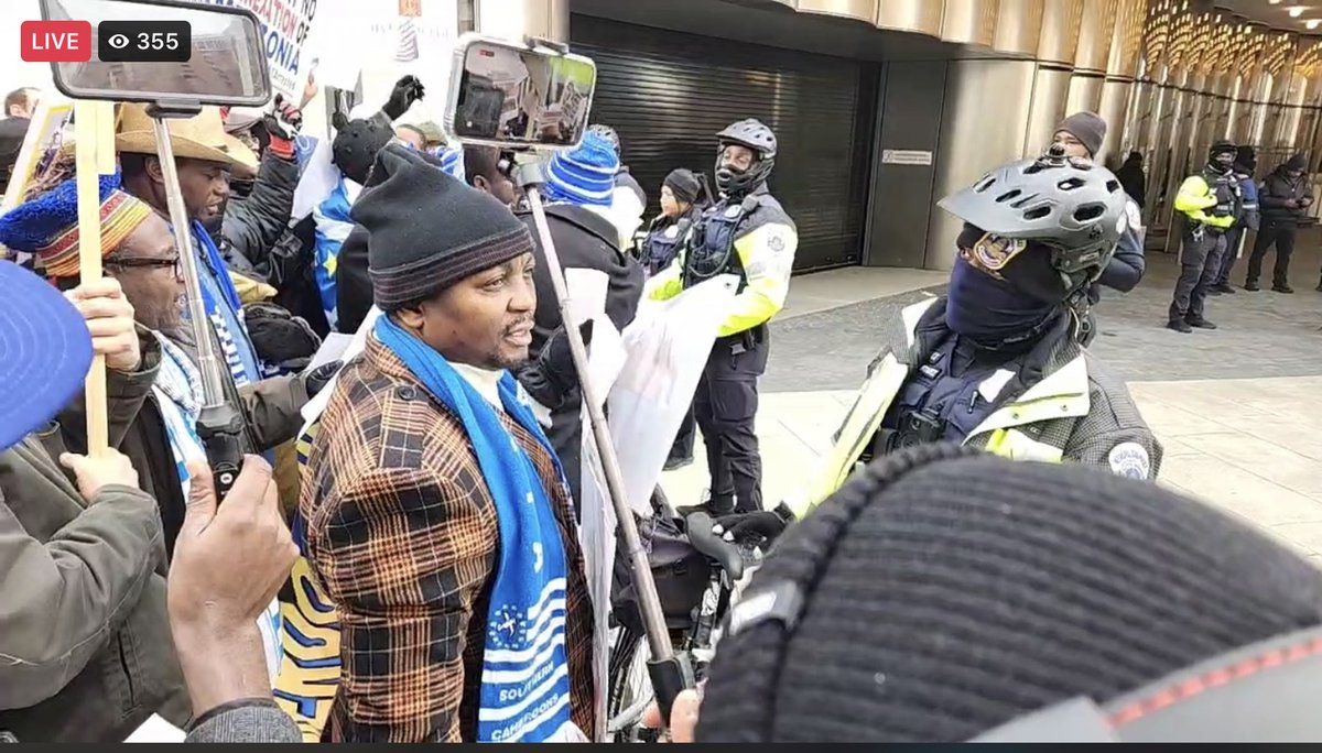 MarkBareta's tweet photo. It is interesting to see how Camerounese have also gathered to see their President while Ambazonians gathered to protest the killings of Ambazonians by Camerounese President. US security officers are guarding and separating both countries citizens to prevent a free for all fight https://t.co/bKn8l5GAfI