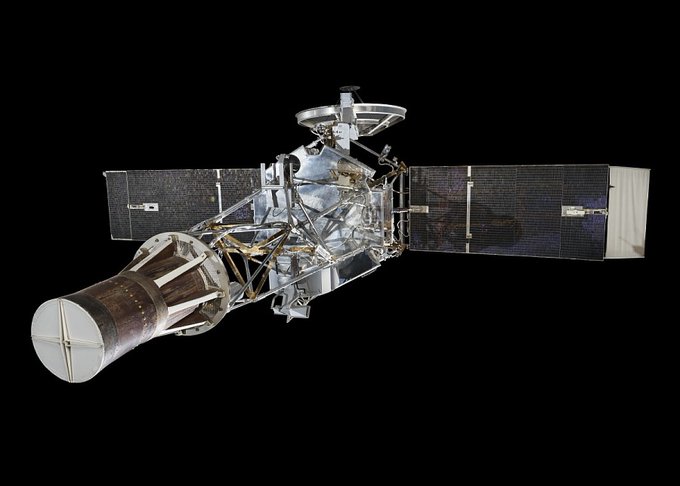 Spacecraft with solar panels deployed against a black background.