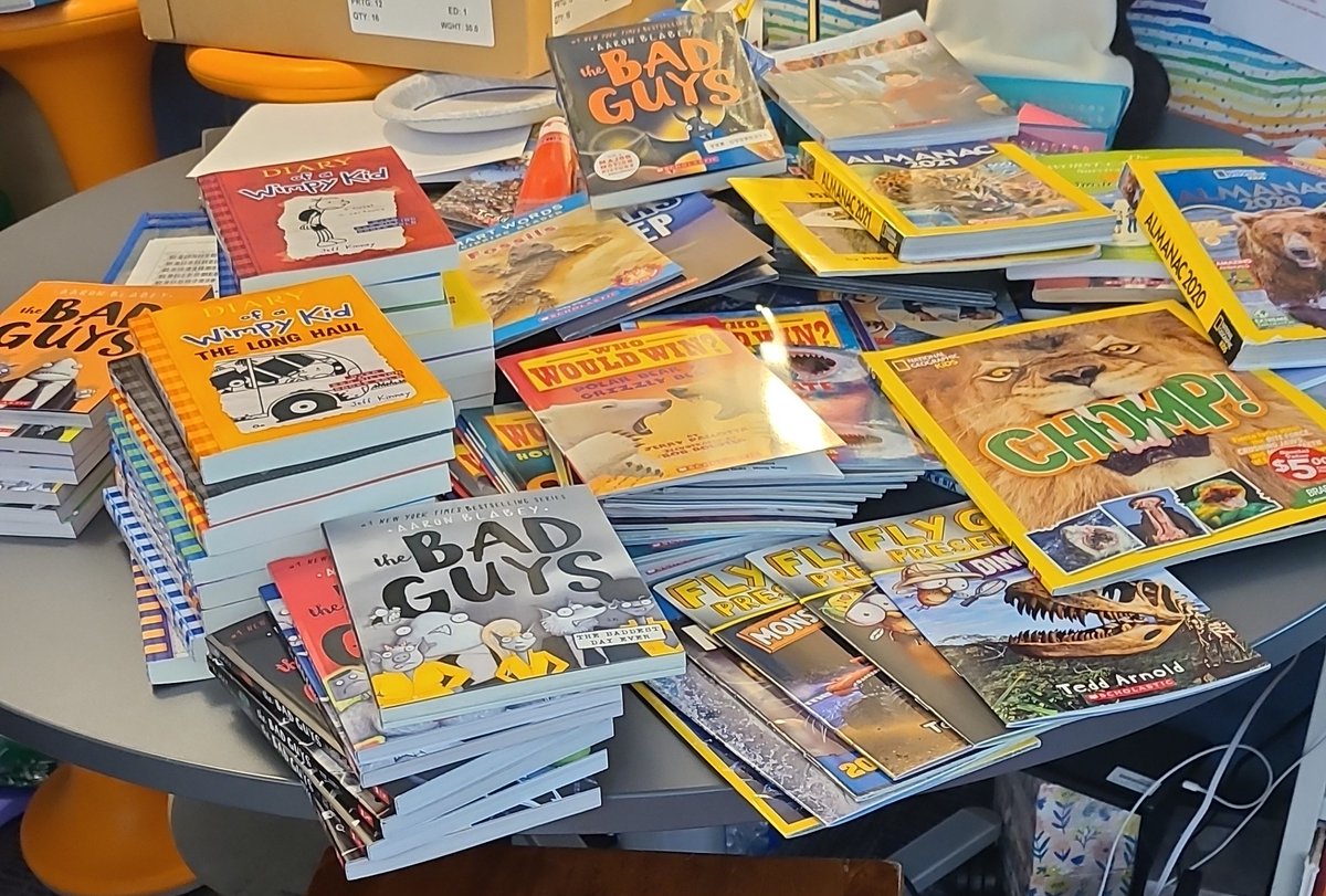 2nd time this week that this table has been filled with piles of new books (student requests) from Scholastic bonus points. The excitement is real! #CommerceEl