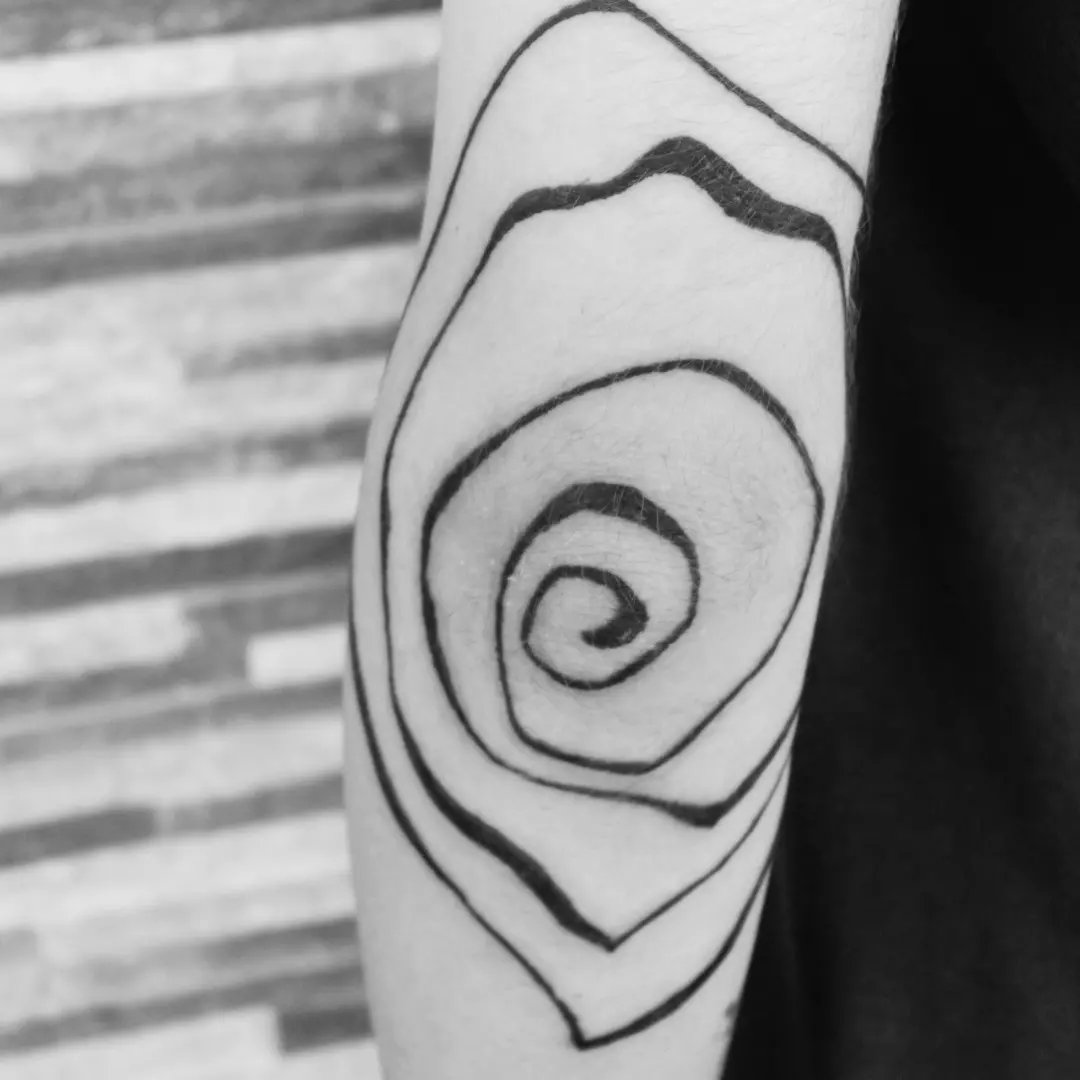 Intervention on artist's body, spiral shape and heads joined by the occipital bone.