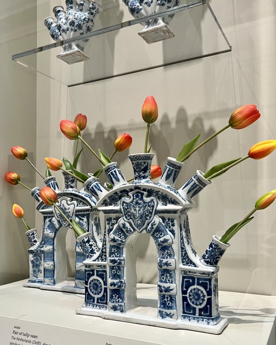 Pair of tulip vases in the form of triumphal arches, each with five upper and two lower spouts with blue and white decoration. 
