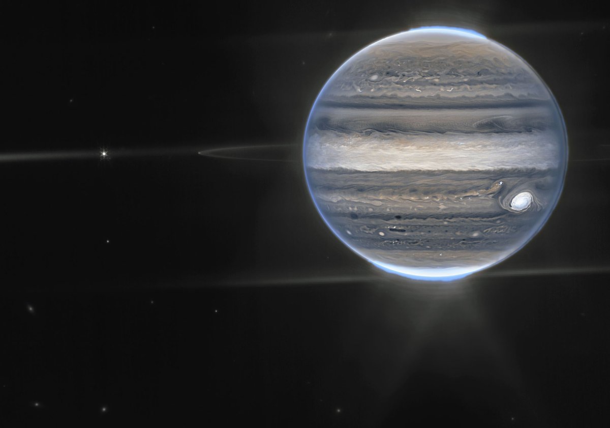 Day 4 of the 2022 Space Telescope Advent Calendar: Rings and Auroras. A false-color infrared composite image of Jupiter made by the James Webb Space Telescope on July 27, 2022. The planet’s auroras, its rings, and some of its small satellites are visible.  theatln.tc/Yo7Iy2K6